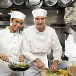 Male and female chefs in restaurant kitchen